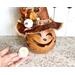 This image shows a Halloween witch decoration. It is made from a real dried gourd. It includes a battery-operated candle.